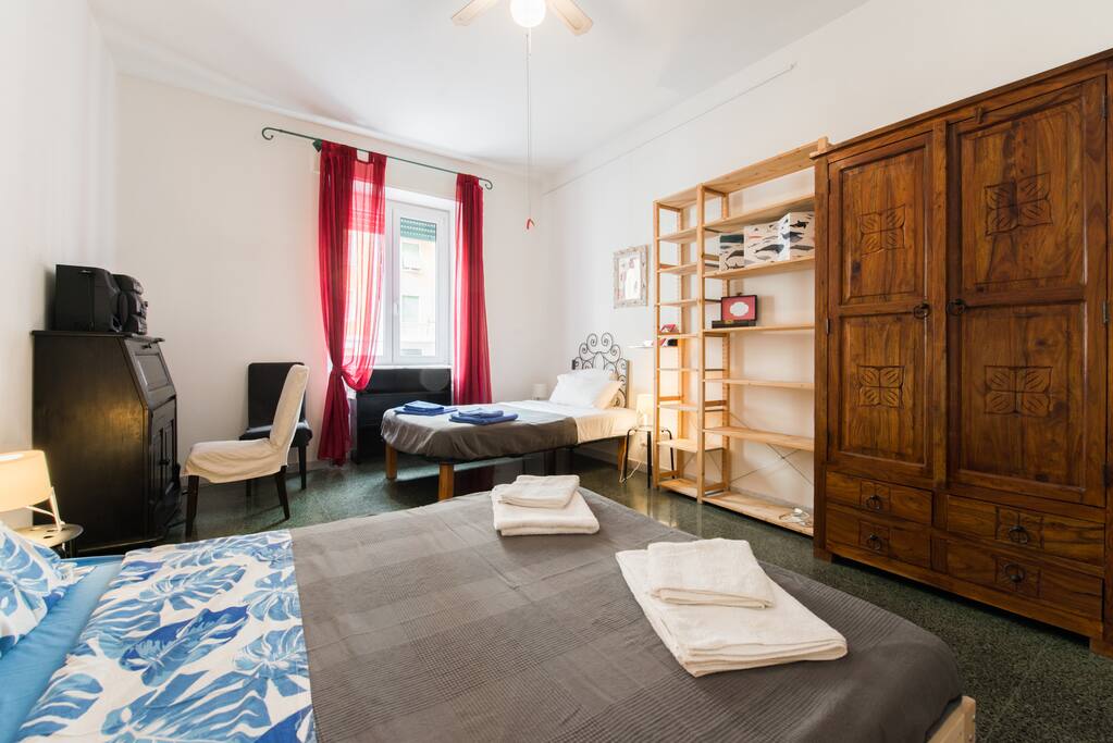 Second bedroom with two beds: one double bed, one bed and a half , a desk, wardrobe, chest of drawers and shelves.