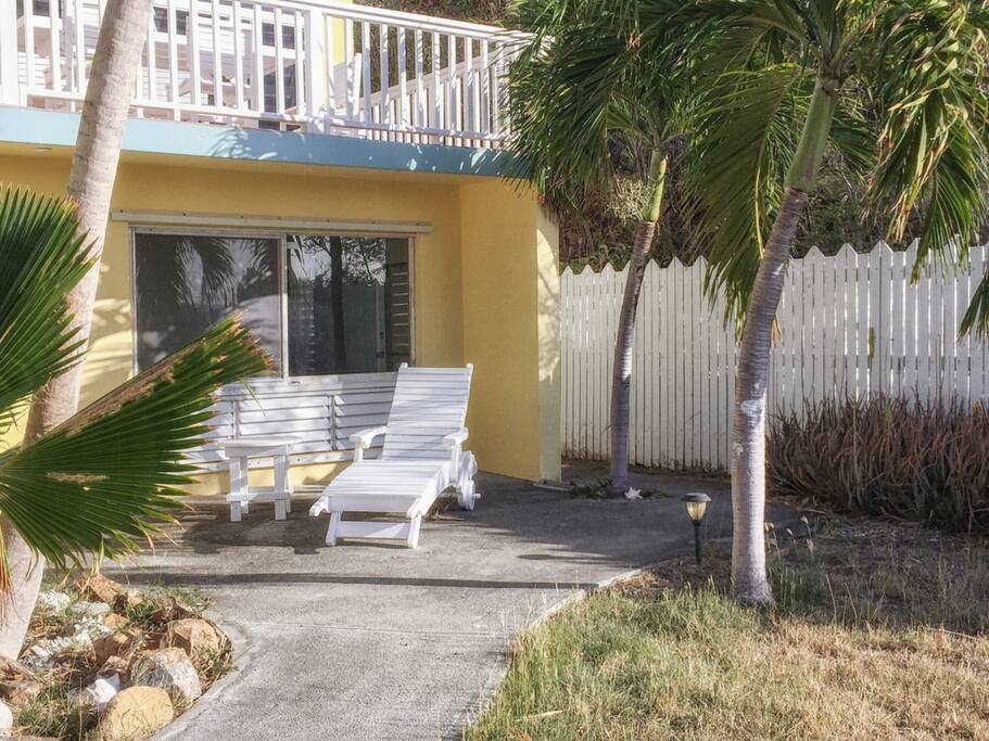 Outdoor shower (rinse off beach sand) and seating area outside of the apartment.