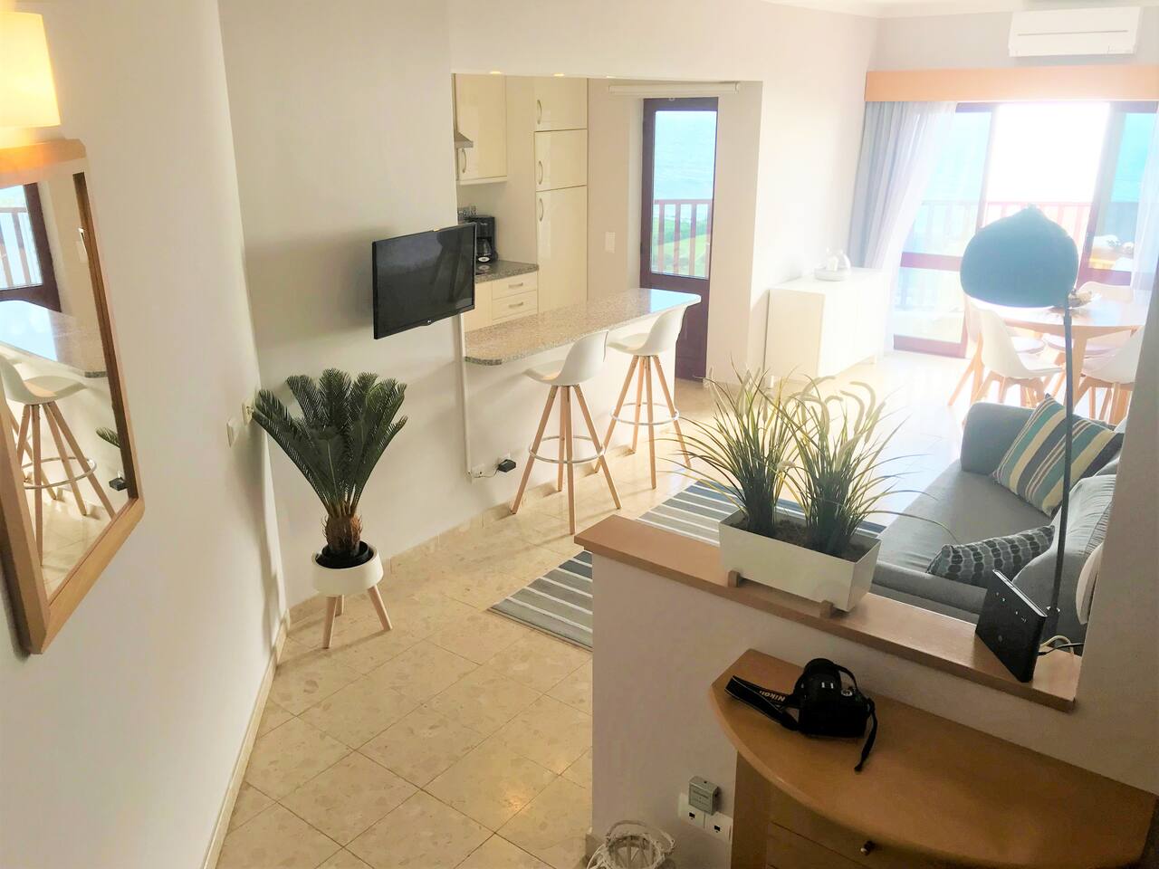 View from Hall to the Living Room with the Balcony and the Ocean Blue on the far side.
