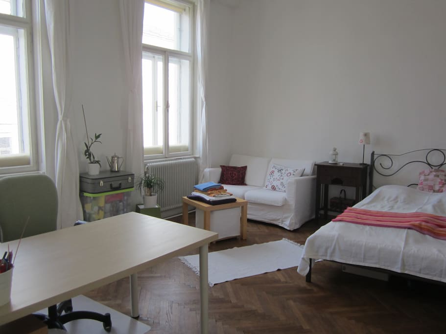 The room with bed, desk and a small sofa
