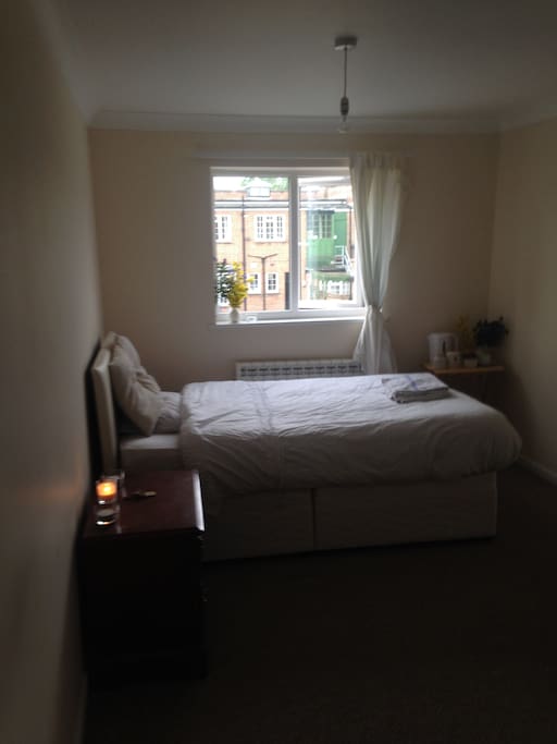 The clean, large and modern guest bedroom.