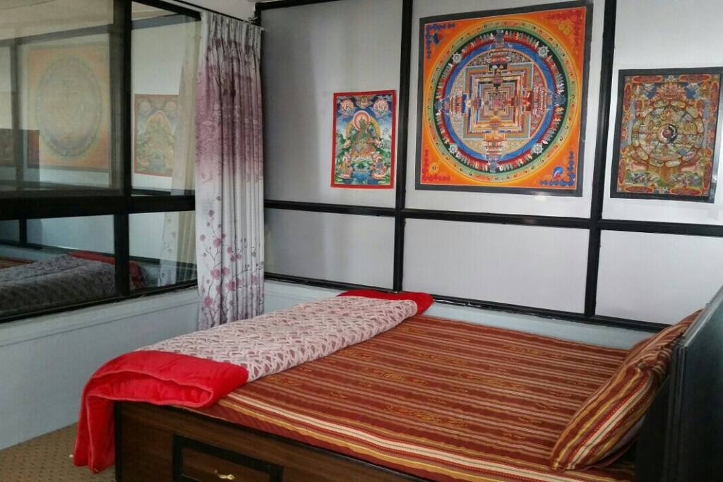 Bedroom attached with kitchen and
toilet opposite to bed left side of painting is kitchen.