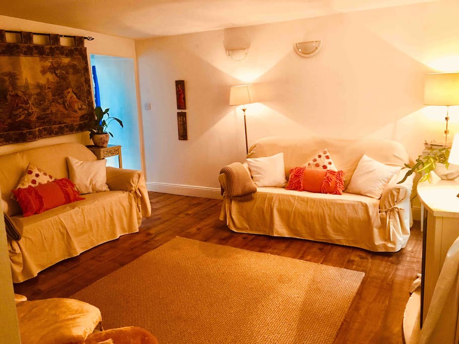 Our cosy cottage sitting room with original fire place and turf burning stove.