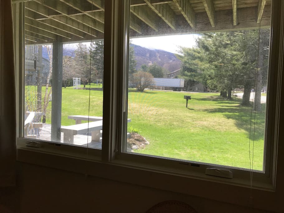Common field with playground, gardens, and grill behind the house (with picnic table in summer). A short walk to common woods trails and stream.