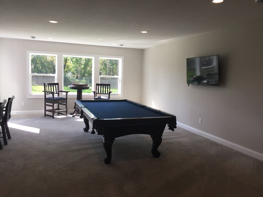 Huge 9 foot billiards/pool table with seating and wallmounted TV