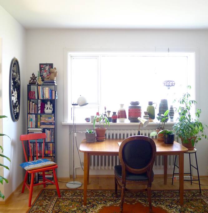 The workspace is a part of the living room and comes with a calming view of the garden.