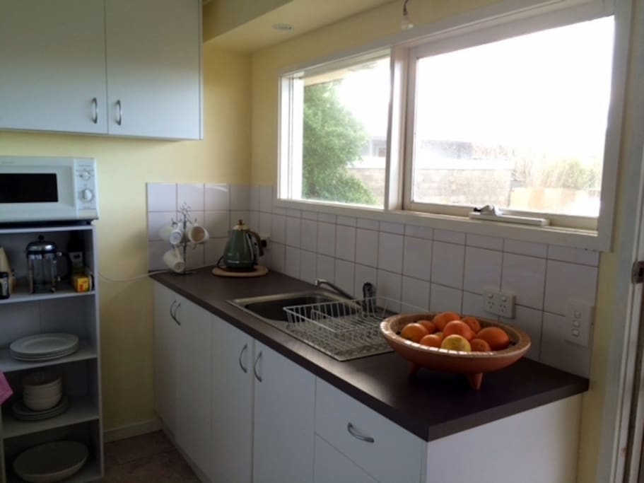 The kitchen is functional and well equipped for meal preparation.