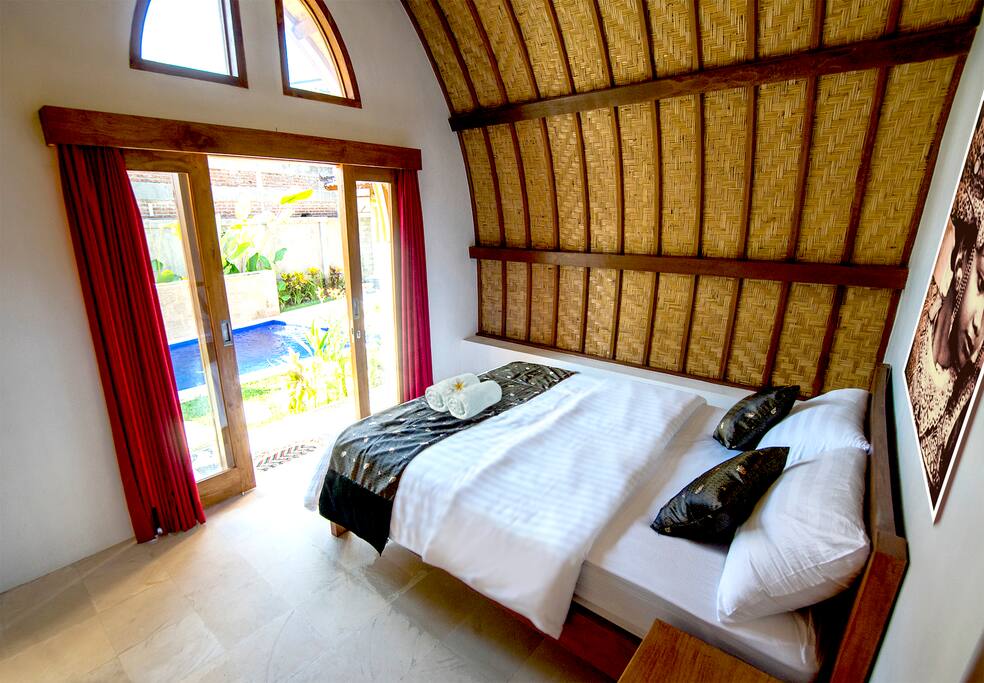Queen bed with comfy western style mattress, AC, fan, computer desk, pool frontage