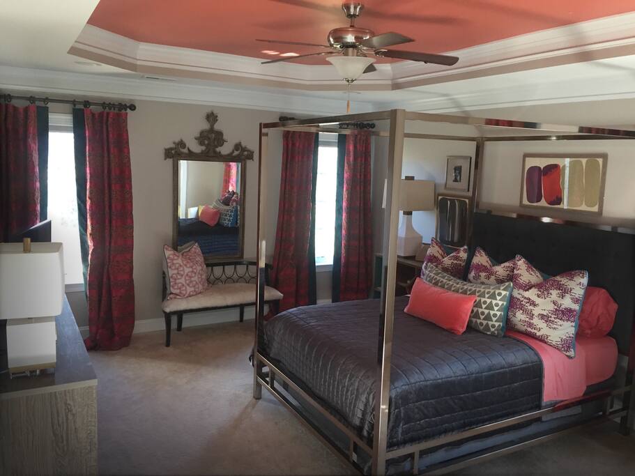 Designer decorated master bedroom with attached large master bath.