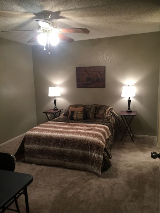 Full size bed with two side tables and lamps