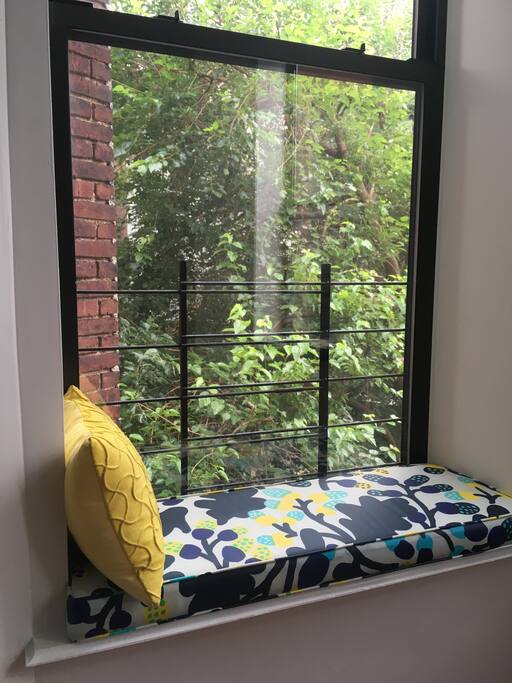 Treetop view from window seat behind dining table.