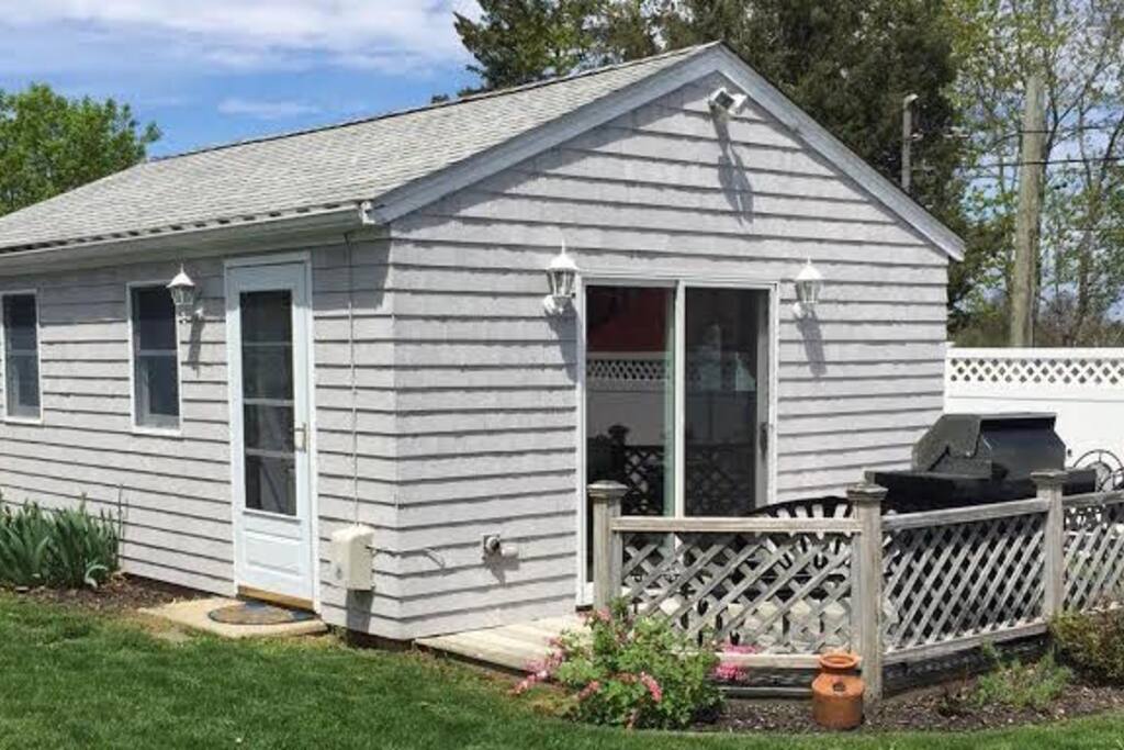 Charming entryway and patio with BBQ off landscaped front yard
