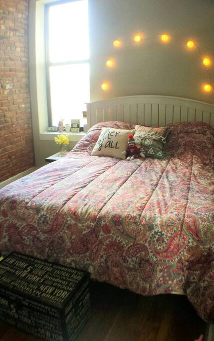 Exposed red brick on the south wall.
