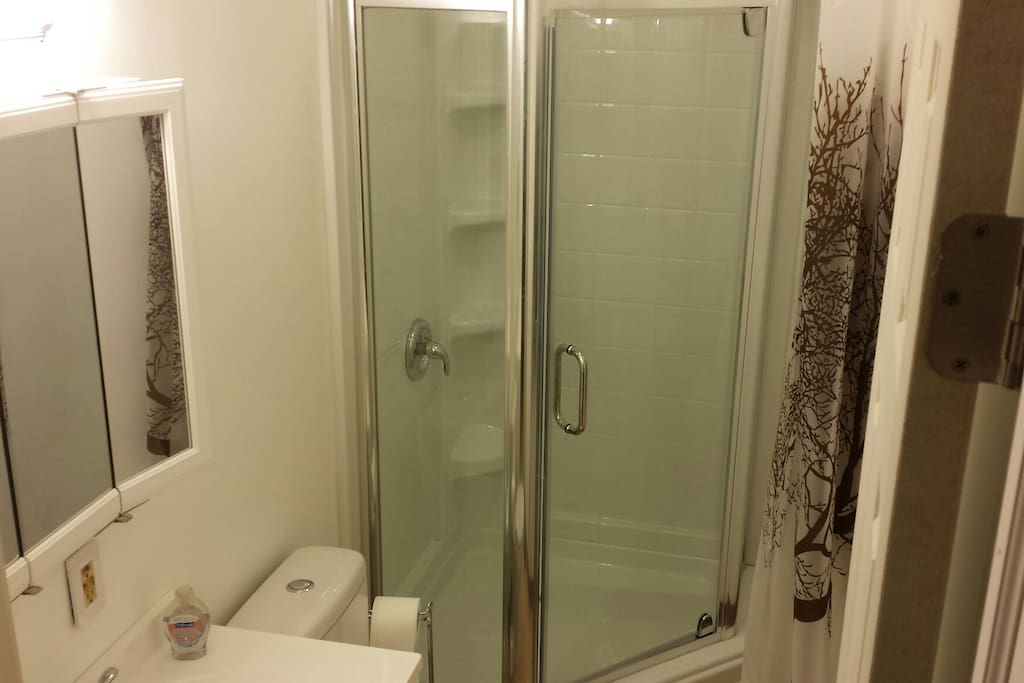 Updated bathroom with glass enclosed shower.