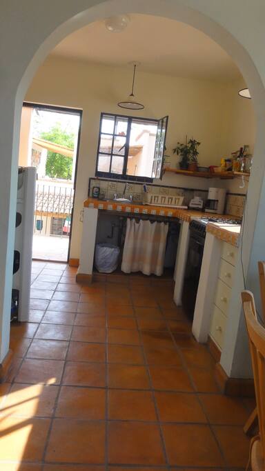 View from dining area to kitchen and out front door.