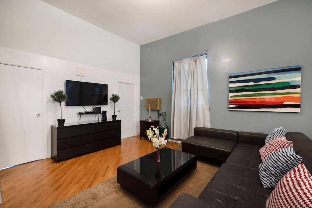 Main seating area includes a large flat screen tv, Wrap around couch, perfect for seating, and comfortable living space for all guests to enjoy. High speed wifi and premium cable included