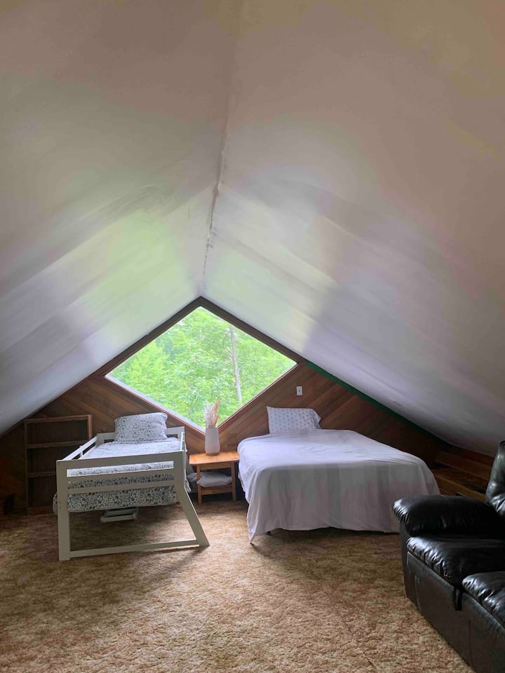 Loft area with two beds and a couch, lots of space.