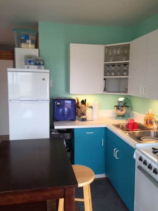 The kitchen is small but very functional with fridge, microwave and other appliances.