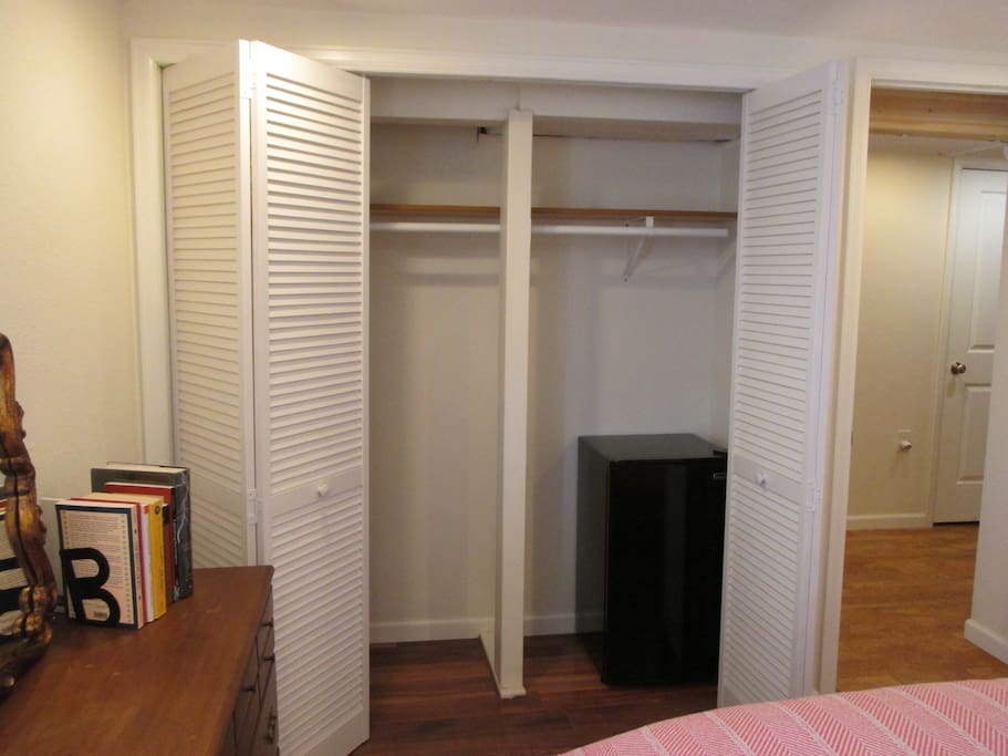 Plenty of space to store luggage or hang clothing + private mini fridge in the closet.