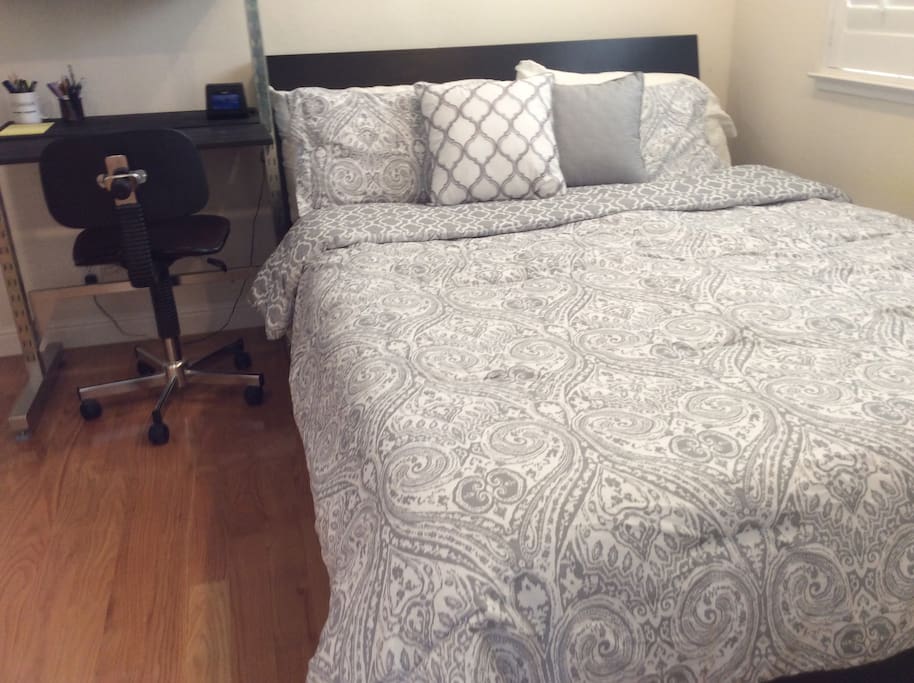 Queen size bed with work desk.