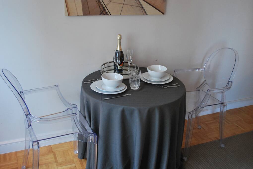 Dining area with full set of dishes, glassware, and flatware.
