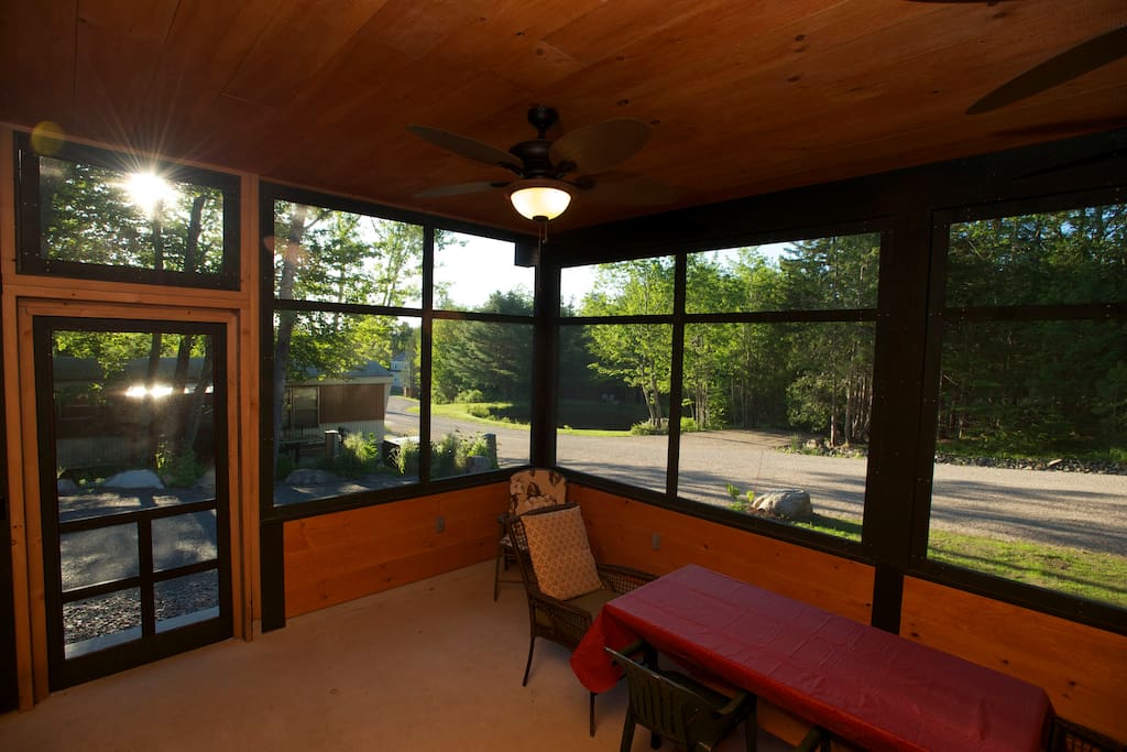 Screened in porch with plenty of space for dining