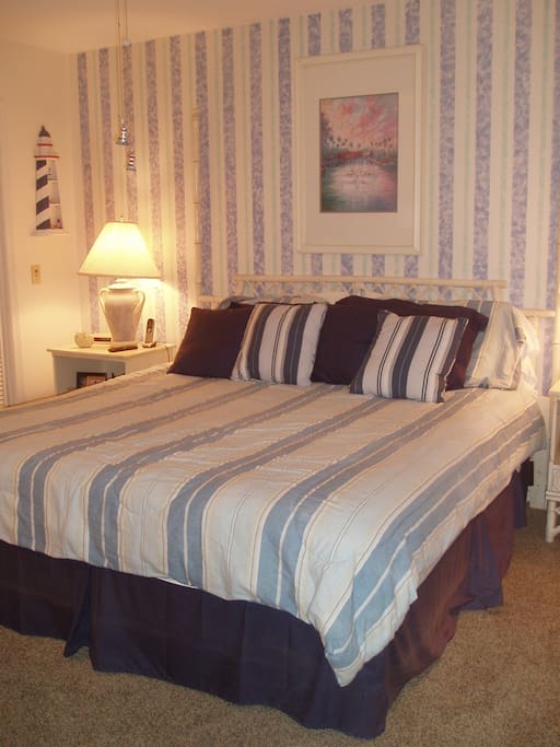 Main floor king size bedroom adjoins screened porch overlooking fairway/Green