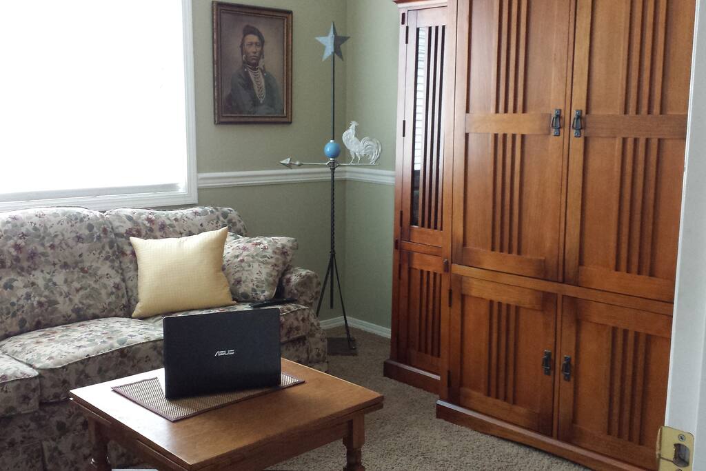 Den with sofa, 40" cable TV, and coffee maker