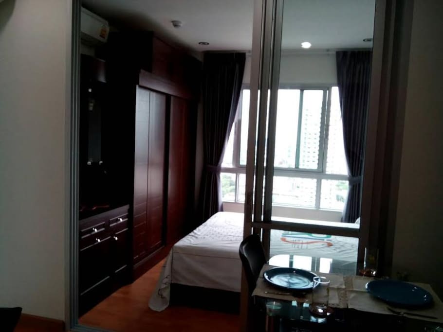 Wardrobe and dressing table. Queen-sized bed with side table.