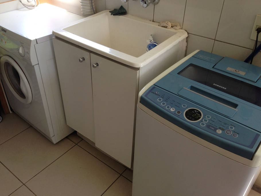 Laundry room with washer and drier available for use.