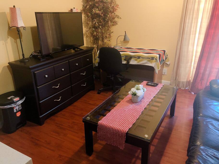 Cozy living room with large screen HD TV and desk