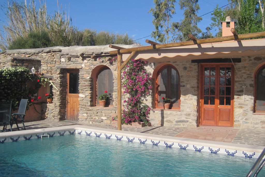 The French doors of the lounge open on to the swimming pool