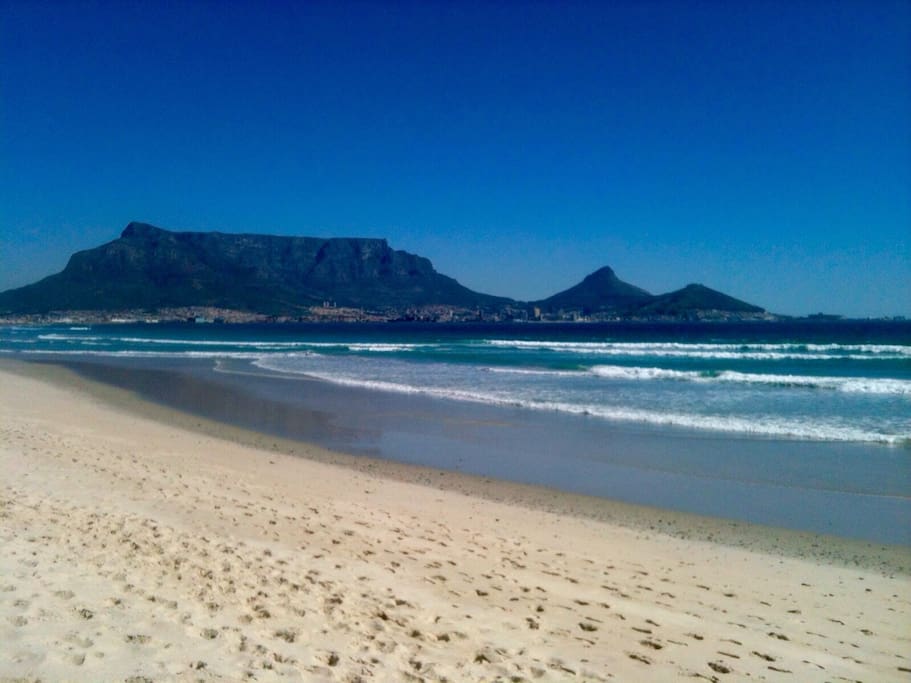 Famous view from our back yard beach: Table Mountain, Lions head,Signal Hill, and on the far right the Cape Town Stadium