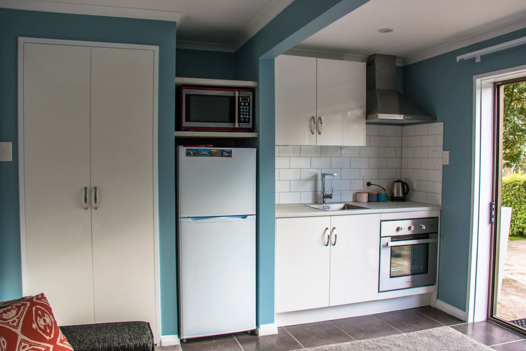 Kitchen area. Built in wardrobe with bedding for sofa bed, rubbish bin, games, puzzles, dvds, clothes hangers ect
