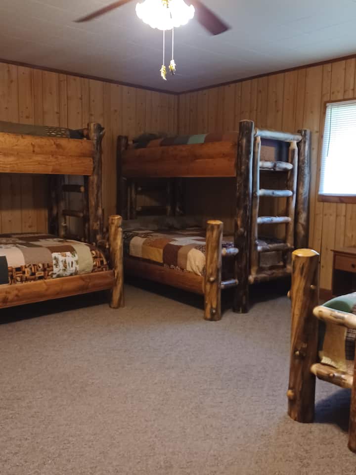 Room has 3 twin over full aspen bunk beds and a walk in closet. Features gorgeous handmade quilts from Tennessee.