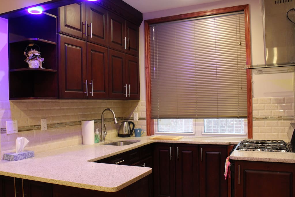 Open Floor Plan Kitchen with Stove, Fridge and equipped with essentials