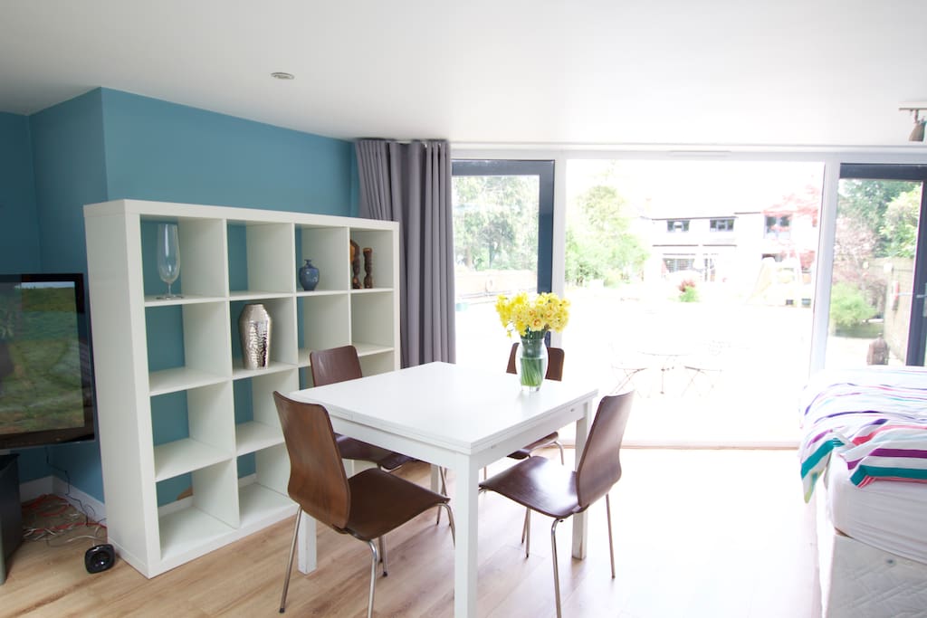 Dining area overlooking pool and garden