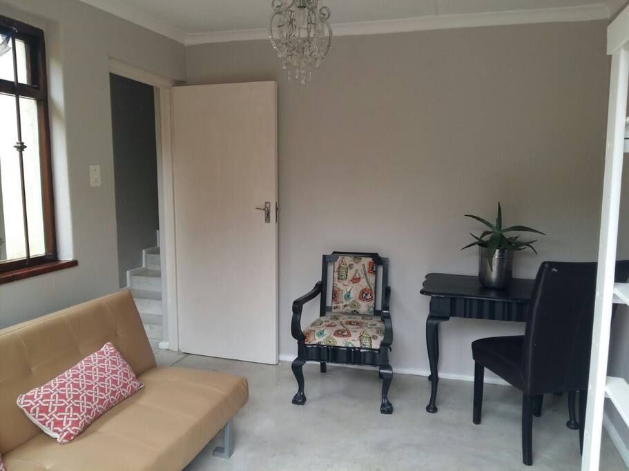 Sunny lounge with bar fridge and microwave.