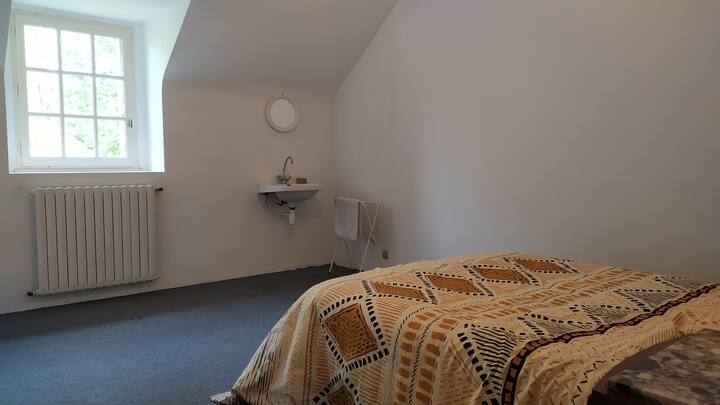 Upstairs bedroom with double bed and water point. 
