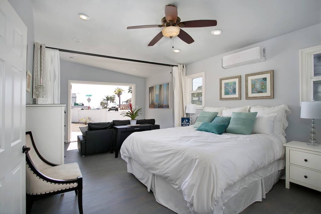 Serene master bedroom features a king-size bed and sitting area.