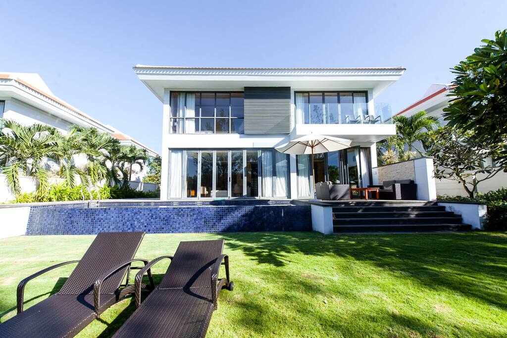 View of villa from the back. You can see the pool and patio area.
