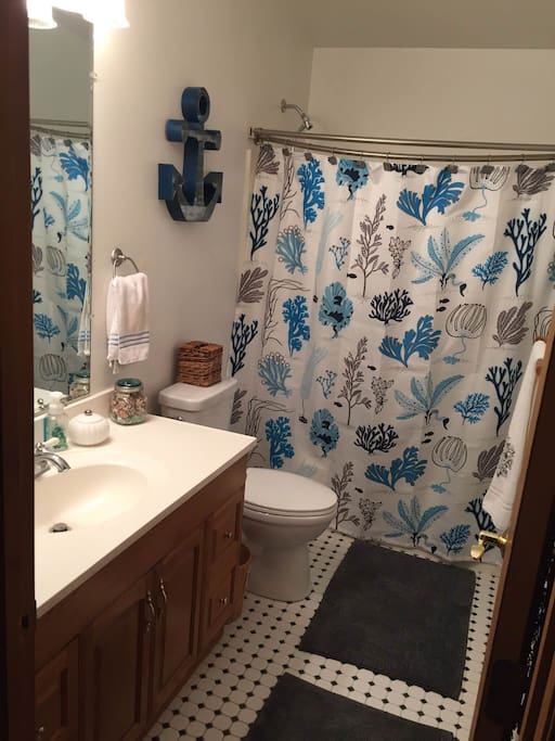 Spacious shower /tub combination in private bathroom.