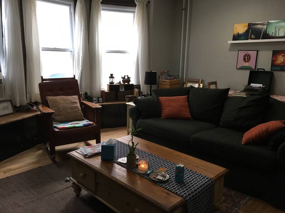 comfortable living room set up with table in the back.
