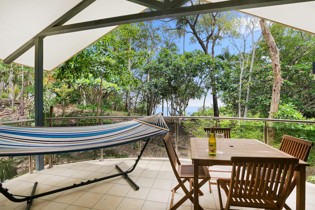 The top patio of the townhouse has beautiful views of the ocean, the parkland and you can take it all in from your own hammock and enjoy the Barbeque provided.