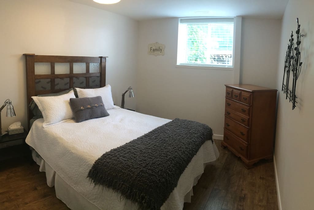Cozy bedroom with queen size bed, full closet, and dresser.