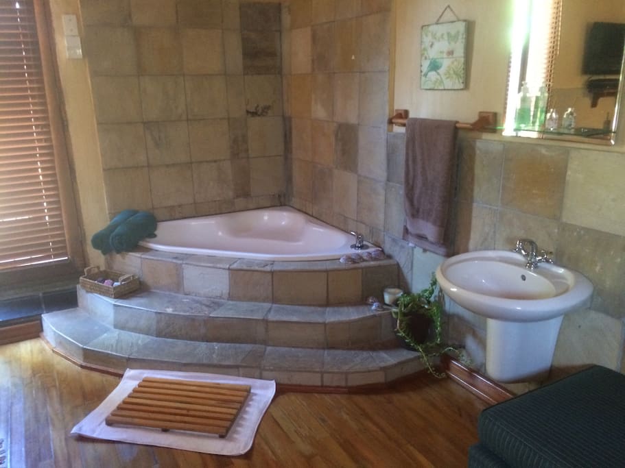 Romantic corner tub in the room.
