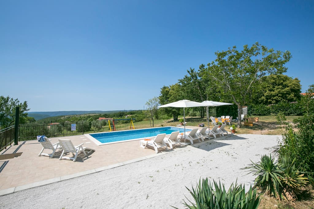 Swimming pool and sun loungers