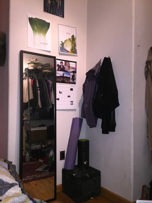 Full length mirror, yoga mat, and foam roller.