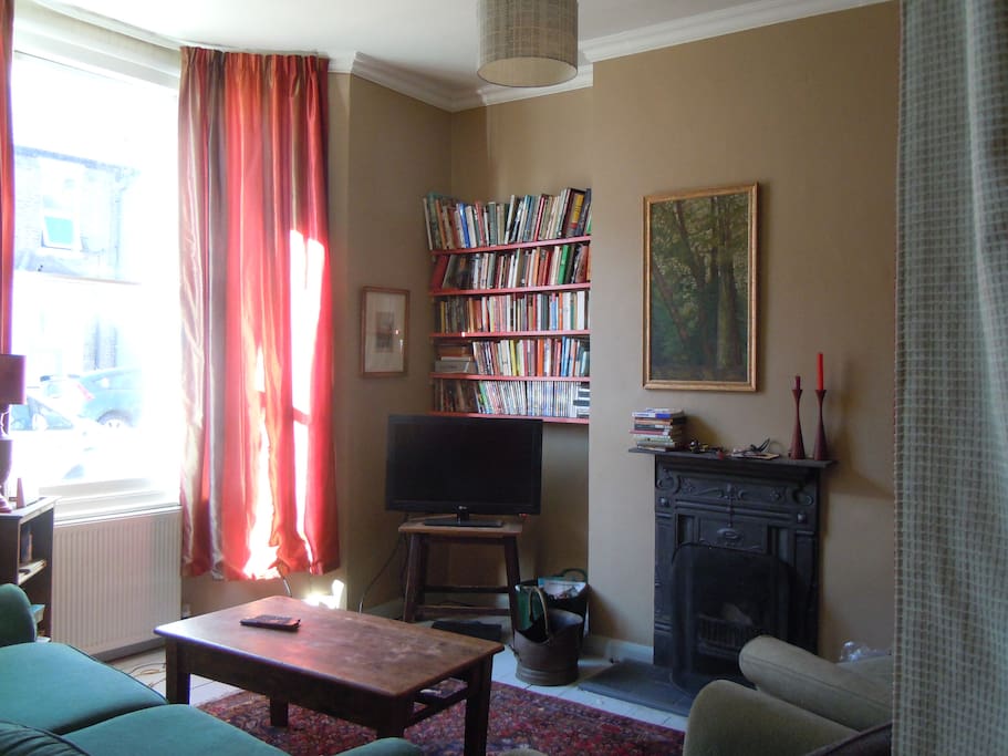 This living room gives onto a further space with an almost in-tune piano. TV and DVD and lots of films on the shelves.