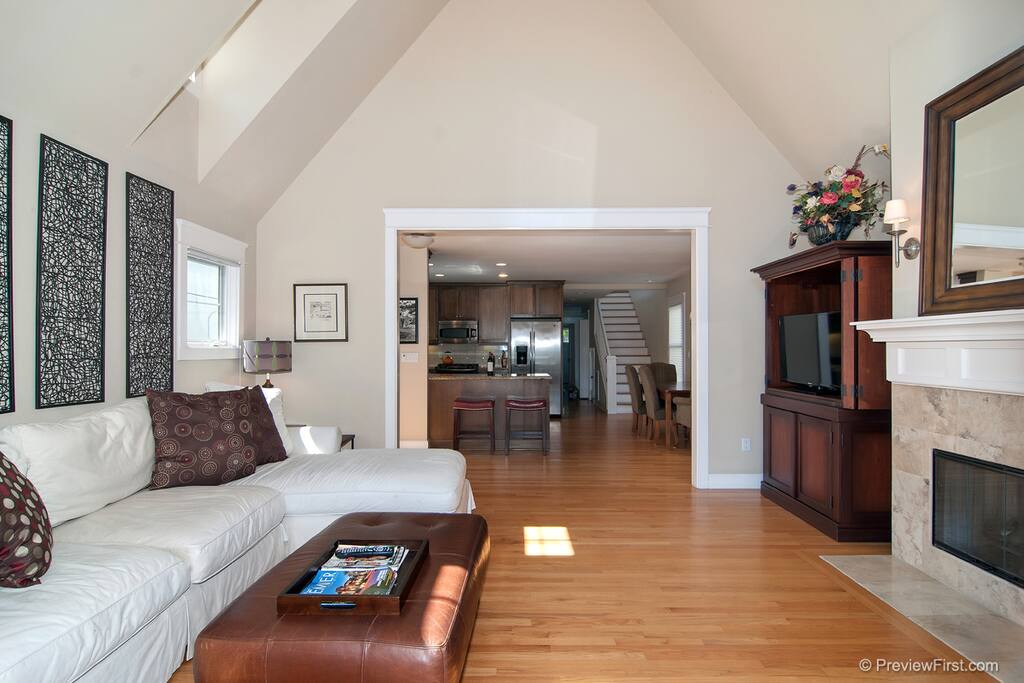 The flowing living room connects seamlessly to the dining room and kitchen